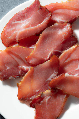 slices of meat close-up with bright light on whete plate. High quality photoの写真素材