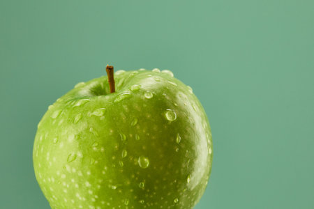 green apple with water drops on a green background. fresh fruit close-up. High quality 4k footageの写真素材