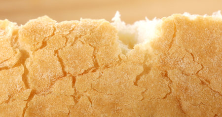 Tearing crust of fresh bread. Texture of bread close up. Slow mation. Sunny day. First person view.