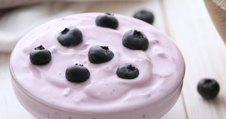 Blueberry Yogurt with fresh berries on a white table. healthly food.の写真素材