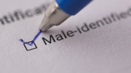 Marking Male-Identified on a Document. Extremely Close-up, shallow dof.