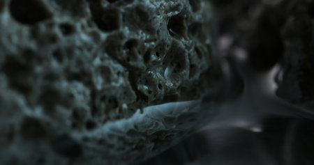 Textured Porous Rock Profile Under Moody Lighting. Close-up, shallow dof.の写真素材