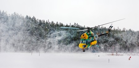 flying up helicopter in a snow dustの写真素材
