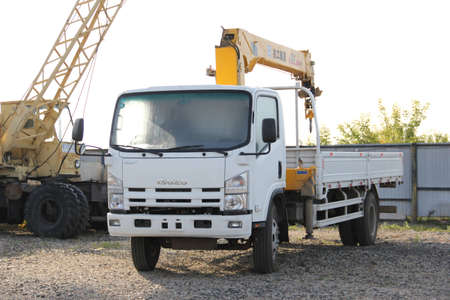 Great white auto truck crane standing on a construction site - Russia, Crimea - September, 21, 2016のeditorial素材