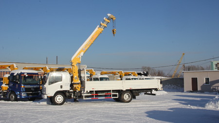 Great white auto truck crane standing on a construction site in winter - Russia, Crimea -January, 21, 2016のeditorial素材