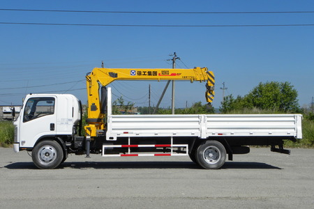 A White Isuzu flatbed truck with yellow crane arm is in the parking lot - Russia, Moscow, 30 August 2016のeditorial素材