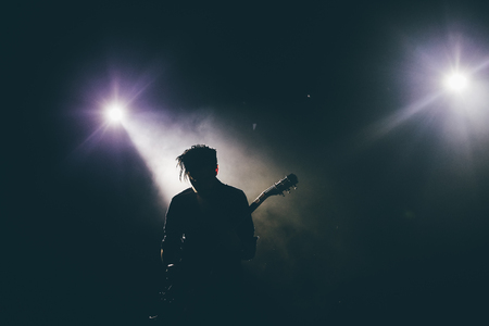 Guitarist silhouette on a stageの写真素材