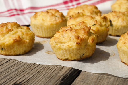 Tasty and healthy cakes muffins vegetables on wooden deskの写真素材