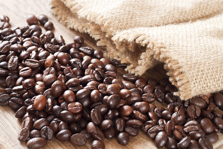 Coffee beans and coffee bag on wooden backround.の写真素材