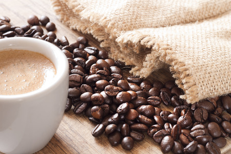 Coffee cup and coffee beans on wooden backround.の写真素材