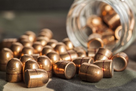 bullets on camouflage background spill out of the banks on camouflage background