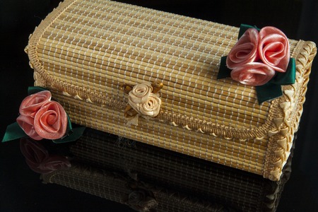 wooden boxes with a classical decoration and flowers on a black backgroundの写真素材