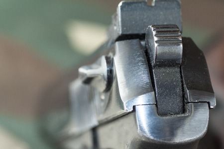 Firearm Pistol Clip And Hand Gun Ammunition on military camouflage backgroundの写真素材