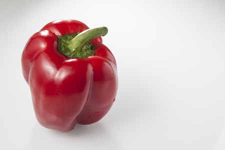 red pepper with water drops on a white backgroundの写真素材