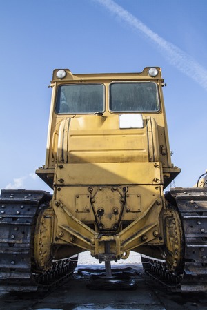 dirty rusty tractor standing on the streetの写真素材