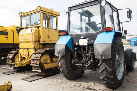 Tractor, standing in a row. Agricultural machinery. Parking of agricultural machinery.の写真素材
