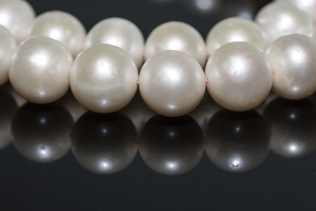pearl necklace on a black background with reflectionの写真素材