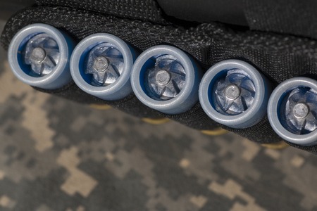 hunting cartridges with plastic sleeves on camouflage backgroundの写真素材