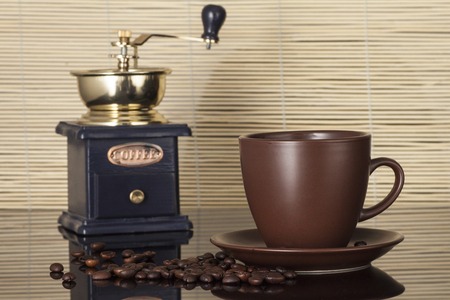still life with coffee beans and coffee mill on the wooden backgroundの写真素材