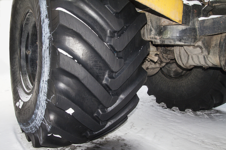 tractor stands on the snowの写真素材