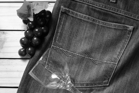 grapes on a jeans and glass . effact back and white.wood backgoundの写真素材
