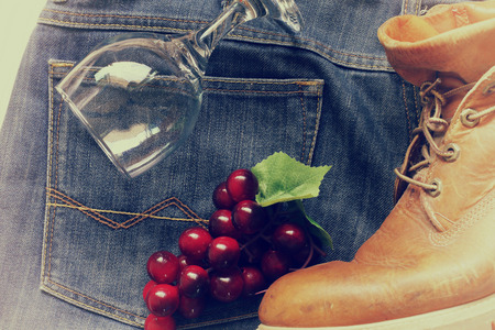 grapes on a jeans and boot and glass . effact vintage style blur and nosieの写真素材