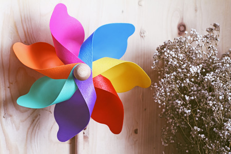 Colored windmill on on wood background .effect vintage.の写真素材