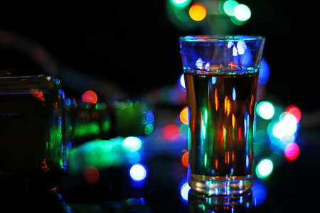 Wiskey in glass with bokeh light on black background .の写真素材