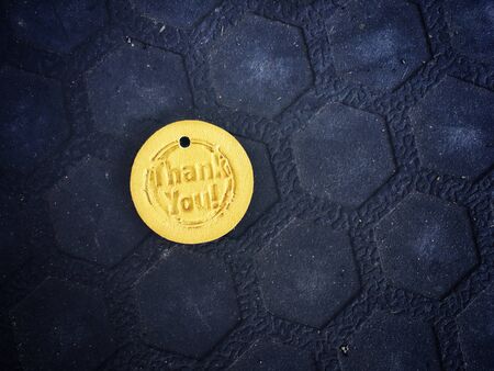 Thank you text in golden coin, close up shot