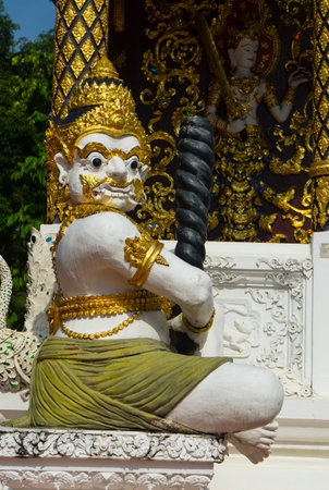 A giant statue sitting in front of the templeの写真素材