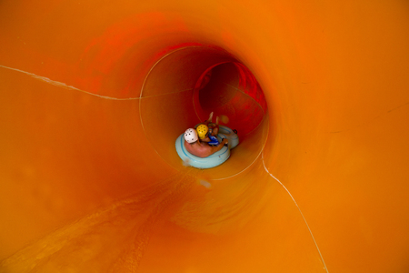 Child with father on water slide at aquapark. Summer holiday.の写真素材