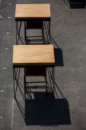 Restaurant furnishings and tableware in a brightly lit outdoor areaの写真素材