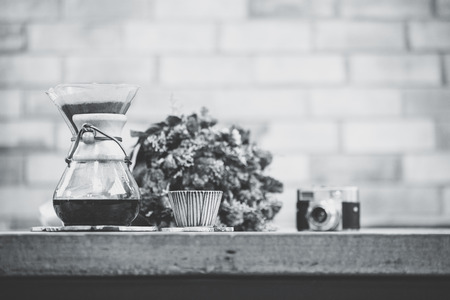 view of ground coffee pouring water on coffee ground with filter, Flower and brick wall background, Colour Retro style. Copy space for your text. Thailandの写真素材