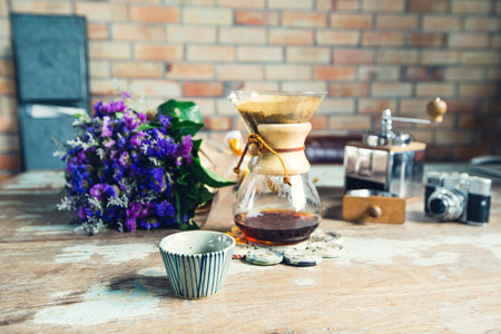 View of ground coffee pouring water on coffee ground with filter, Flower Film Camera and brick wall background, Colour Retro style. Copy space for your text. Thailandの写真素材