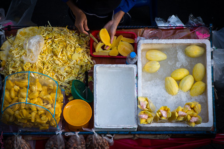 Fruit shop with mango slices and jackfruit . Street food in Bangkok . Thailand.  south east asiaのeditorial素材