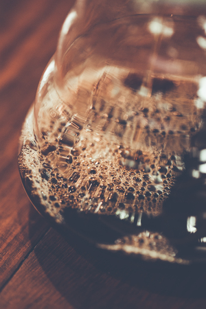 Bubbles Black coffee in a glass kettle .Colour retro style. wooden background , Focus only bubbles. Thailandの写真素材