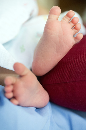 A close-up of tiny baby feet happy family concept. Beautiful conceptual image of Maternityの写真素材
