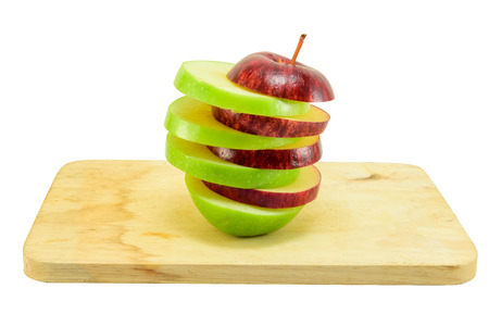 Red and green apple sliced on wooden block isolated on white with clipping pathの写真素材