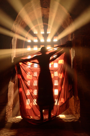 novice is dressing in robe in front of stunning light (Blurry, out of focus)の写真素材