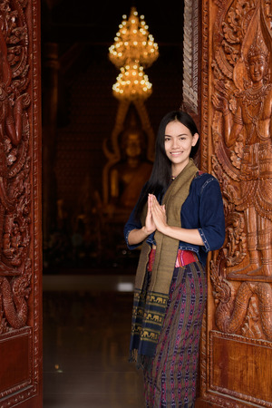 Asian woman wearing typical (Traditional) Thai dress in templeの写真素材