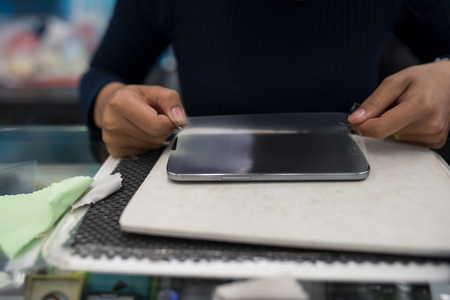 installation of protective cover film on the smartphoneの写真素材