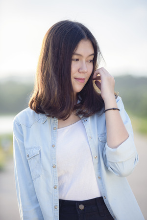 beautiful girl portrait during sunset smiley happy with nature backgroundの写真素材