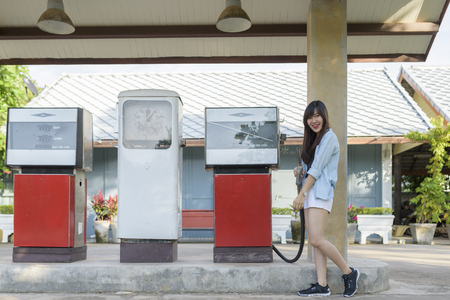 Portrait of  asian woman at vintage gas stationの写真素材