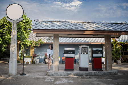 Portrait of  caucasian woman at vintage gas stationの写真素材