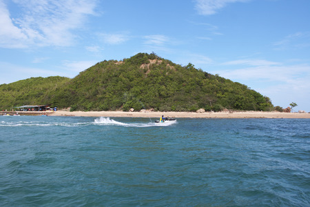 Island and blue sky with one jet skiの写真素材
