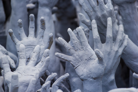 This photo are stucco hand to ask them to help haul up from hell.の写真素材