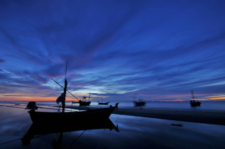 Sea and boat at sunsetの写真素材