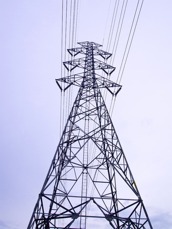 High voltage post against gradient white skyの写真素材