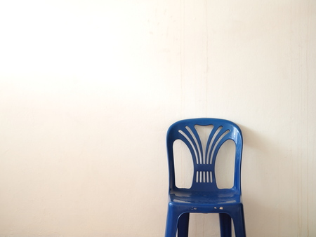Blue chair in front of wall with warmの写真素材