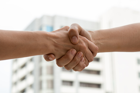 Close up of Partner shaking hand after business deal, business partnership coorperationの写真素材